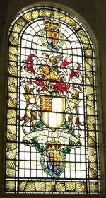 The coat-of-arms of the Royal Society as a stained-glass window. The motto is 'Nullius in verba'.
