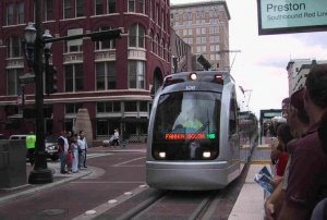 The first line of the light rail system has been opened. In this picture, a MetroRail train is approaching a station in Downtown Houston, Texas